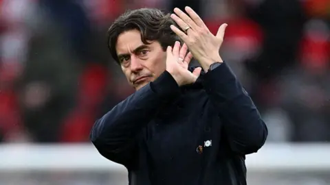 Thomas Frank claps the fans