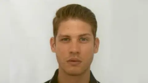 A police mugshot of a young man. 