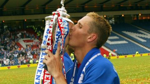 Rangers' Peter Lovenkrands celebrates with the Scottish Cup