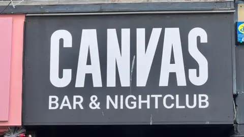 BBC A picture taken from the front of Canvas nightclub. There is a black logo with white text.