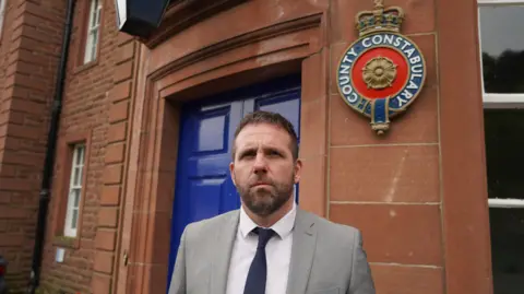 Cumbria police Police boss Matt Scott outside a police station