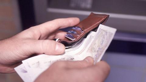 Cash being put in a wallet
