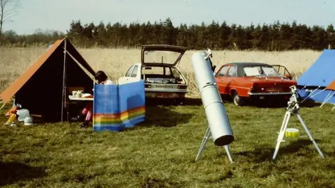 Loughton Astronomical Society A picture from 1988 shows tents set up, cars parked and telescopes on grass. 