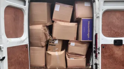 Cyrilyn Moore The white van packed with boxes