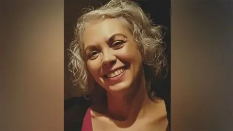 Humberside Police Family photograph of Helen Harrison she has blond curly hair and is wearing a black top