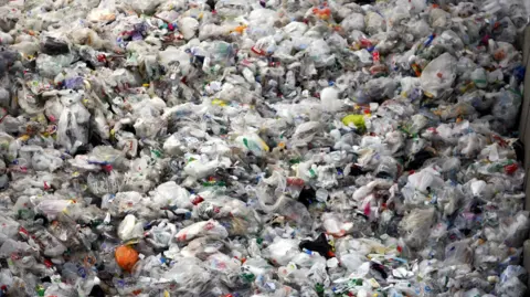  Press Association A huge pile of rubbish containing plastic carrier bags