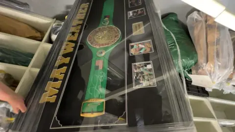 A signed and framed Floyd Mayweather boxing belt.
