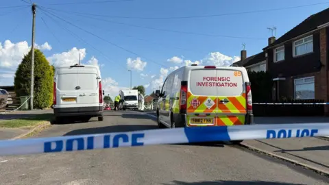 BBC Police tape and forensic van in Biddle Road, Littlethorpe