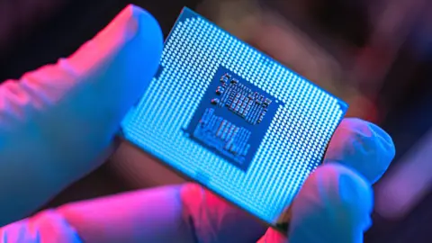 Getty Images Person holding a computer chip.