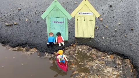 Andy Conroy Toy beach huts at a pothole