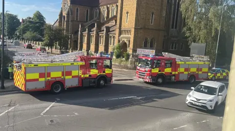Two fire engines and a fire service car parked on the side of the road at Kingsley Park Terrace in Northampton.