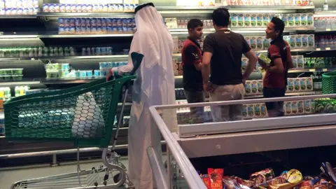 AFP Customers are seen shopping at the al-Meera market in Doha on 10 June 2017