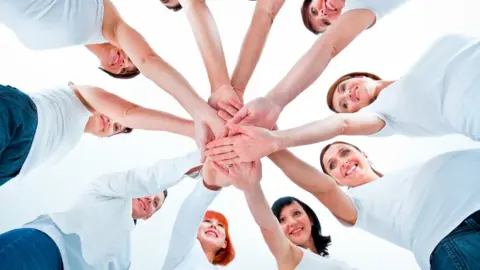 Getty Images Women placing hands into a circle