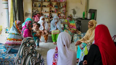 Women at 'Iram's' house learning about the election process