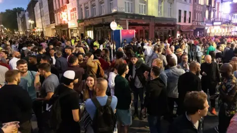 EPA Revellers drink and socialise in the street in Soho, London