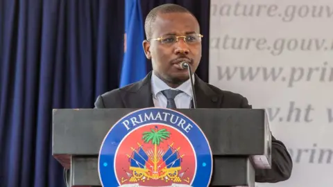 Getty Images Claude Joseph speaks during a ceremony at the Prime Minister's Office on July 20, 2021 in Port-au-Prince, Haiti.