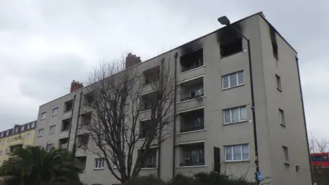 London Fire Brigade Image showing Maddocks House, with blown-out windows and smoke damage to a top-floor flat.