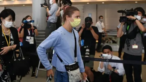 AFP Krystina Timanovskaya walks with her luggage inside the airport