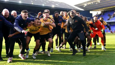 Maidstone United manager George Elokobi celebrates with the players after the Emirates FA Cup fourth round match at Portman Road, Ipswich. 