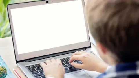 Getty Images Boy-on-the-internet-with-laptop-computer
