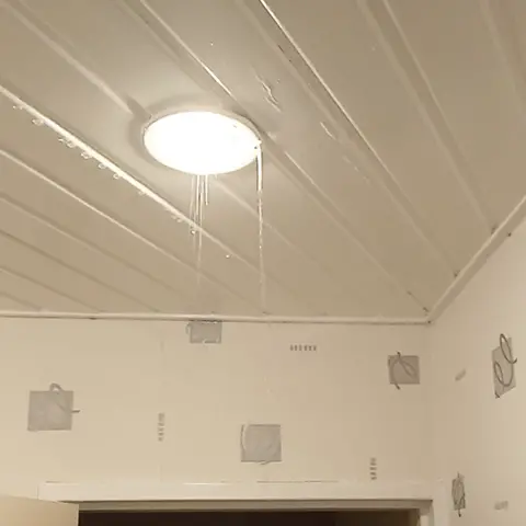 Dimitrios Kampouris A white light fitting with water coming from it.