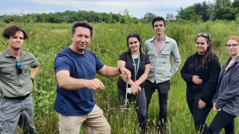 AFP Dr Jones and his students with a snake