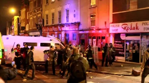 Police and rioters on Stokes Croft in Bristol in 2011