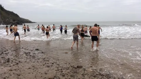 Josh Pike People running into the sea