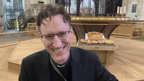 David Webster/BBC Canon James Reveley in front of bread