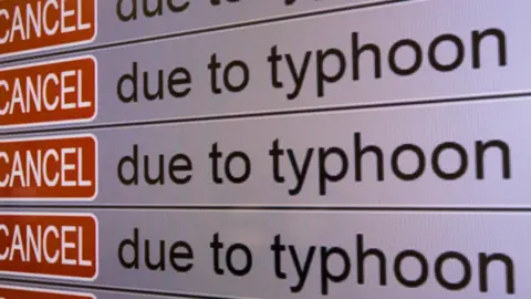 Getty Images Display shows cancelled flights at Fukuoka Airport as Typhoon Haishen approaches on September 06, 2020 in Fukuoka, Japan.