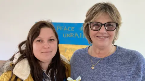 Jenny Kirk/BBC Alla Irodenko from St Olga's Ukrainian Church in Peterborough with Alison McCormick who has donated medical supplied to the people of Ukraine
