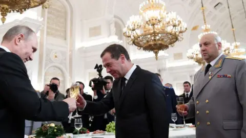 Getty Images Vladimir Putin, Dmitry Medvedev and Sergei Surovikin at the award ceremony for the Russian military who fought in Syria, 2017