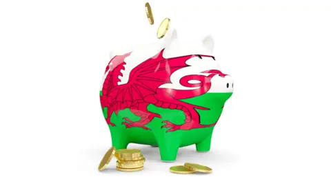 MikhailMishchenko/Getty Images Wales' flag on a piggy bank