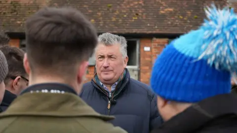 BBC Trainer stood in front of reporters at stable