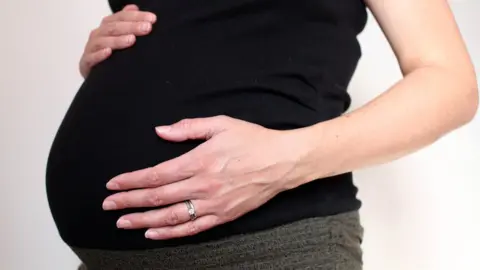 PA/Katie Collins File photo dated 05/09/10 of a pregnant woman.