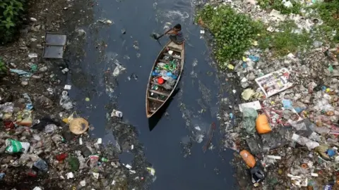 Reuters A boat travels through plastic