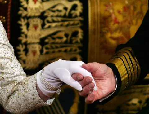 PA The Queen and Prince Philip hold hands