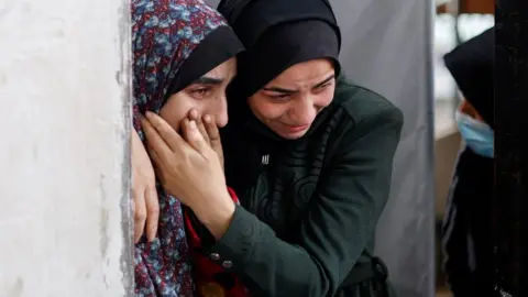 Reuters Palestinian women react at the Abu Yousef Al-Najjar hospital in Rafah, in the southern Gaza Strip (12 February 2024)