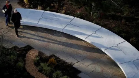 Reuters People walk around the newly opened "Glade of Light" memorial