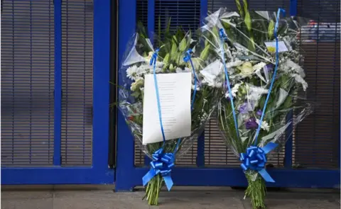 Getty Images flowers left at police station