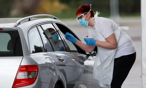 Reuters Health worker at drive-in coronavirus testing centre