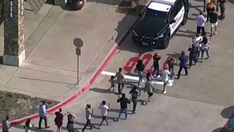 Reuters People leaving mall after shooting