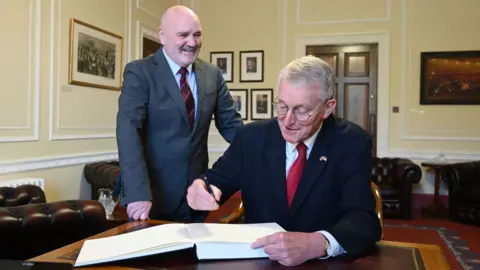 Michael Cooper Hilary Benn welcomed to Stormont's Parliament Buildings by Assembly Speaker Alex Maskey