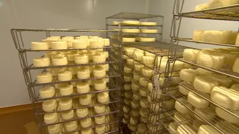 BBC A stack of Traditional Welsh Caerphilly Cheese in a dairy