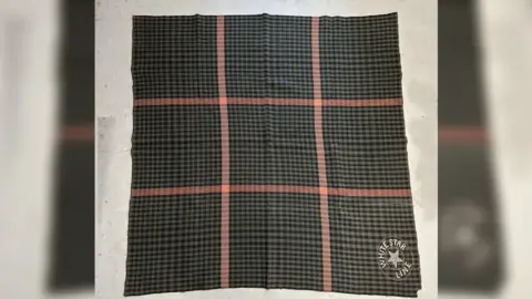 Henry Aldridge & Son Ltd A green/brown/tartan blanket with a red checked pattern with the White Star Line logo in the bottom right corner.