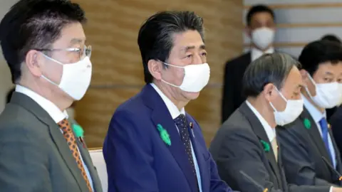 Getty Images Prime Minister Shinzo Abe, centre, declared the state of emergency at a special meeting of medical experts