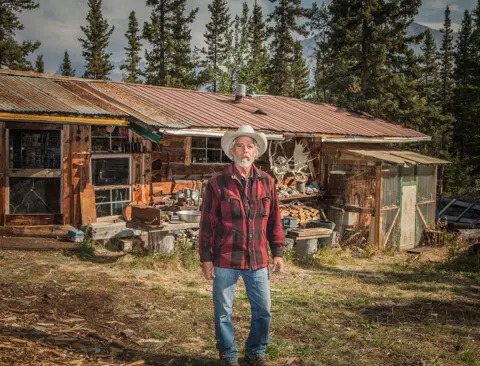 Ian Brown Gary Green standing outside a house