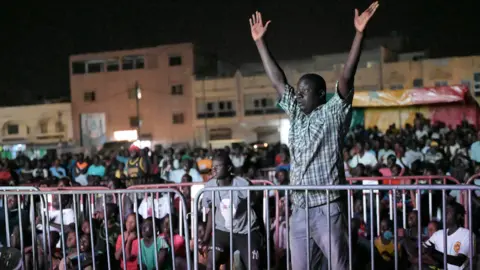 AFP Senegalese watch a live broadcast of the Qatar 2022 World Cup Football semi-final match between Morocco and France at Parcelles Assainie in Dakar on 14 December 2022