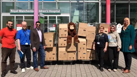 Eid Unwrapped staff and volunteers with cardboard boxes