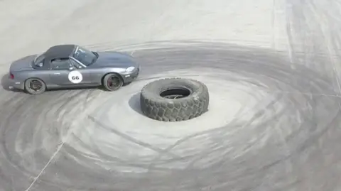 Car skidding around a tyre